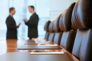two men having a discussion in a conference room
