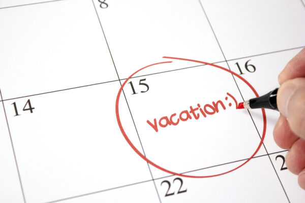 Desk calendar with the word vacation circled on the 15th