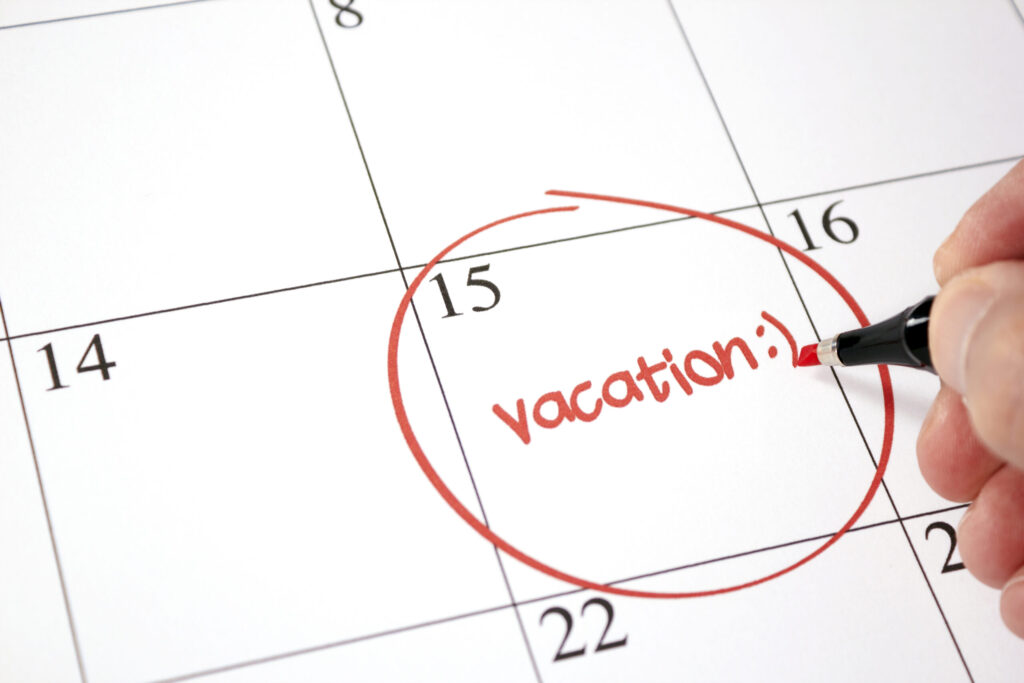 Desk calendar with the word vacation circled on the 15th